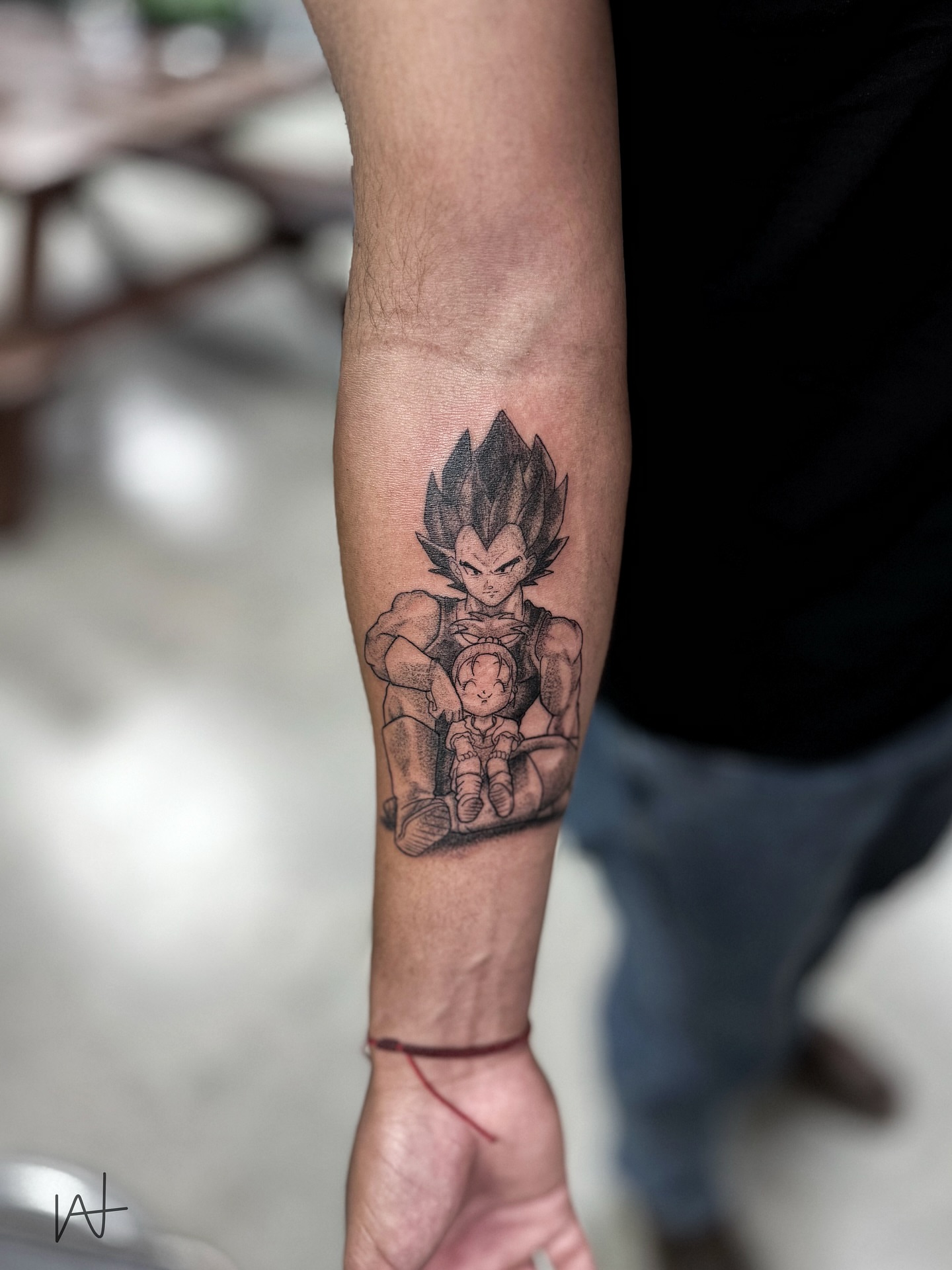 Vegeta and child black and grey tattoo on the forearm by Kat Parmu