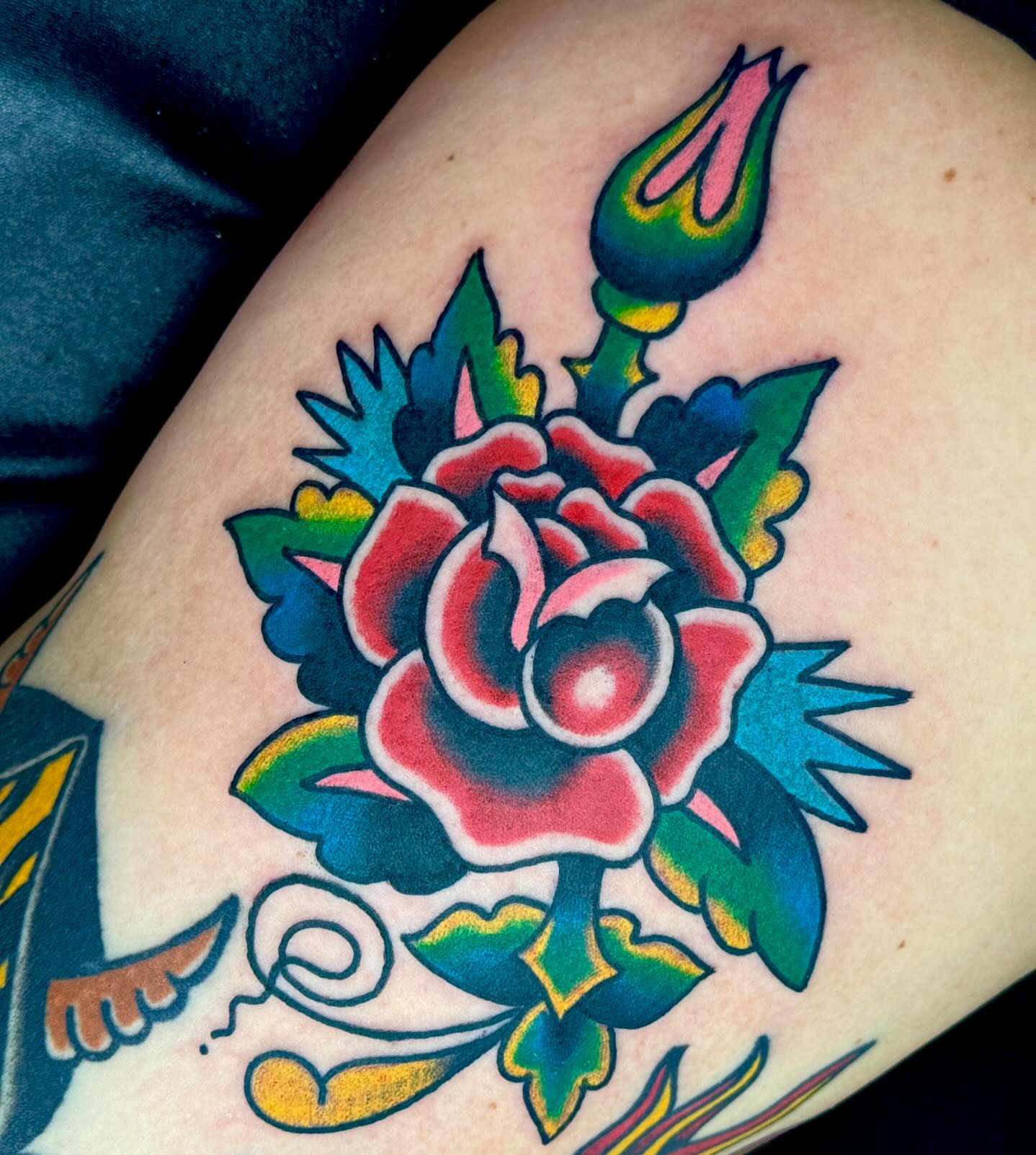 Rose American traditional tattoo on the thigh by Sam Hambrick, Watchung NJ