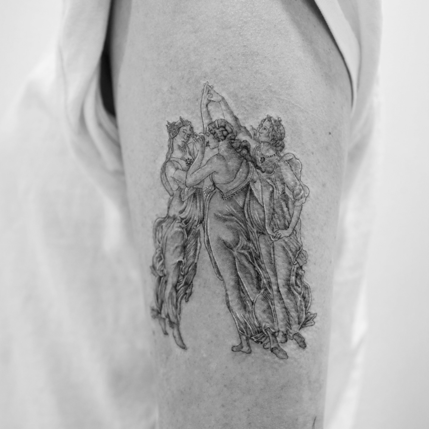 Dance scene realism tattoo on the upper arm by Ross Clark Tattoos