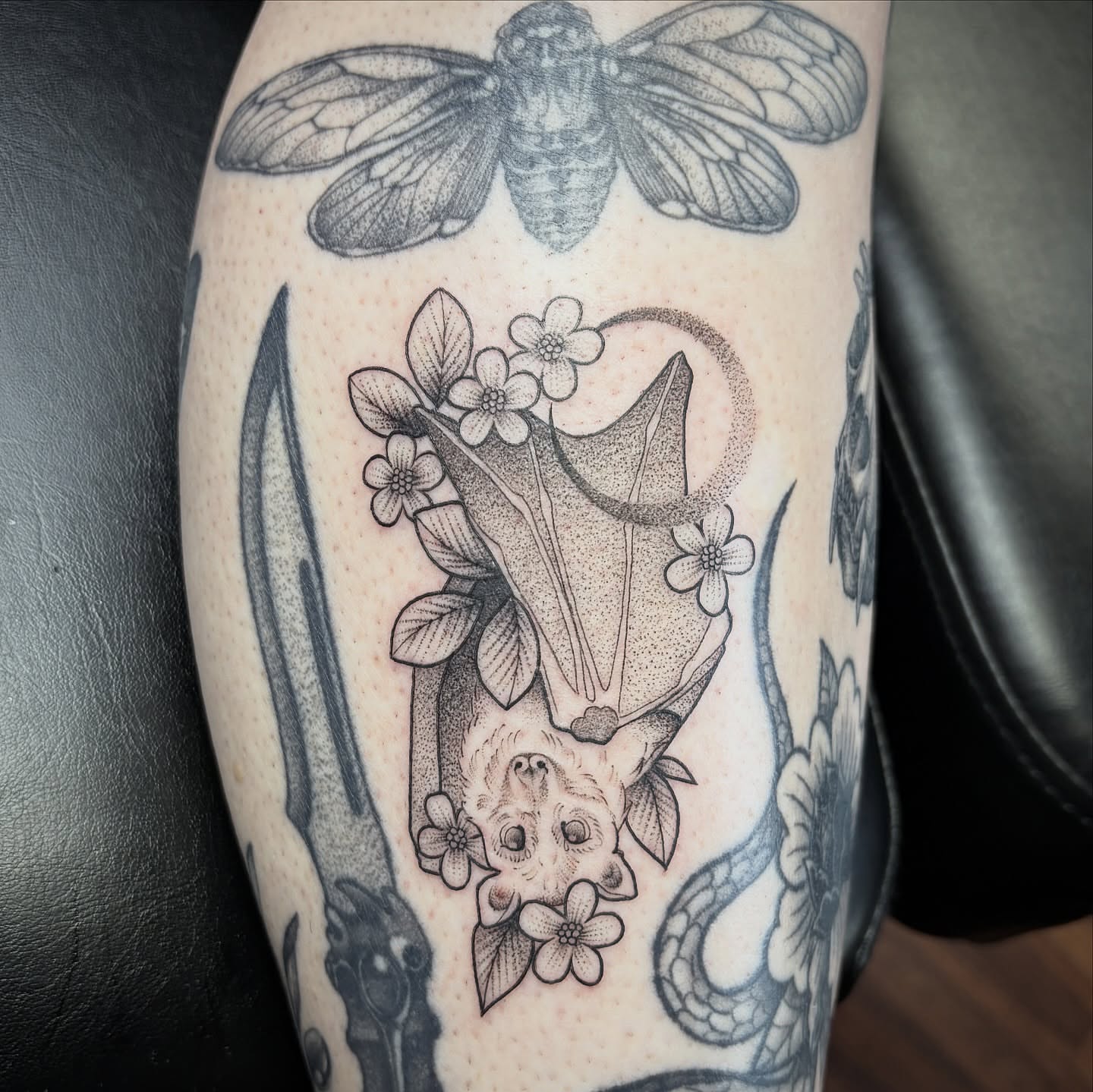 Bat and flowers dotwork tattoo on the forearm by Kelli Donegan ๐ท