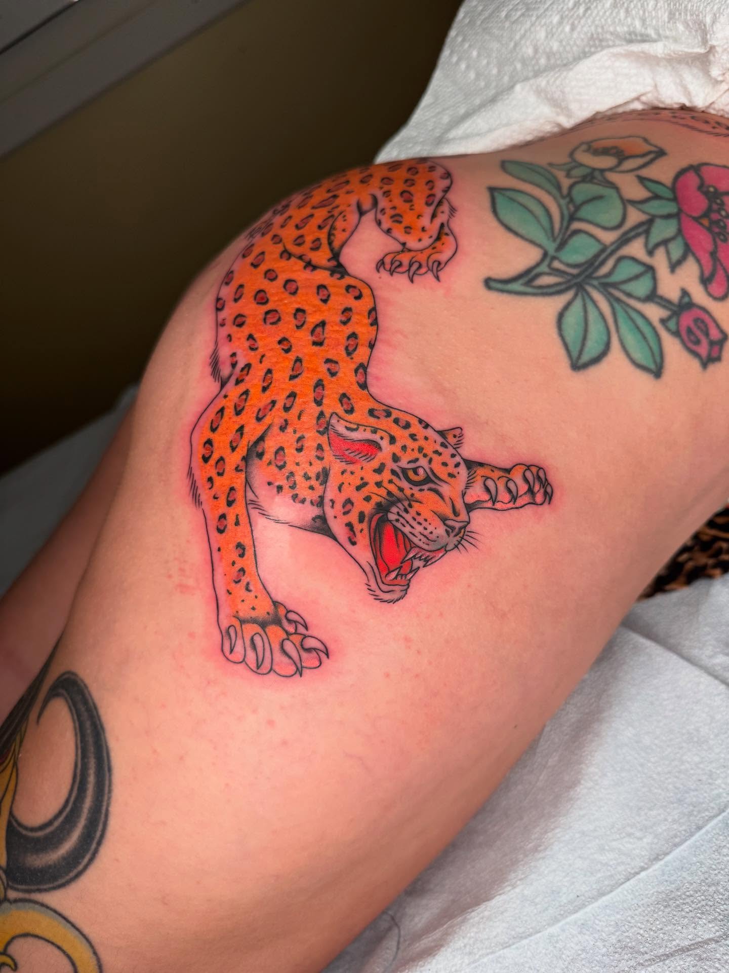 Leopard American traditional tattoo on the thigh by Maddie Hammell