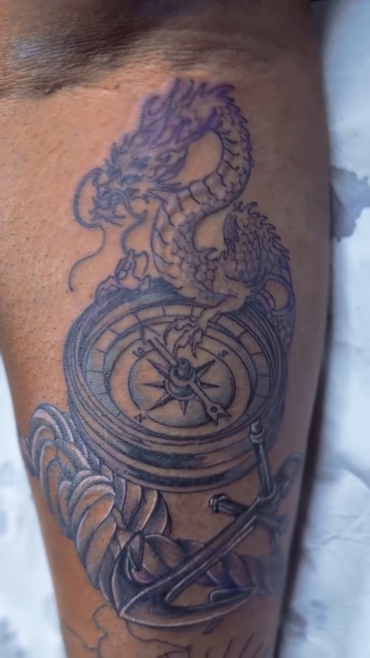 Dragon and compass tattoo Japanese tattoo on the upper arm by oxideTattoo, Morne-à-l'Eau