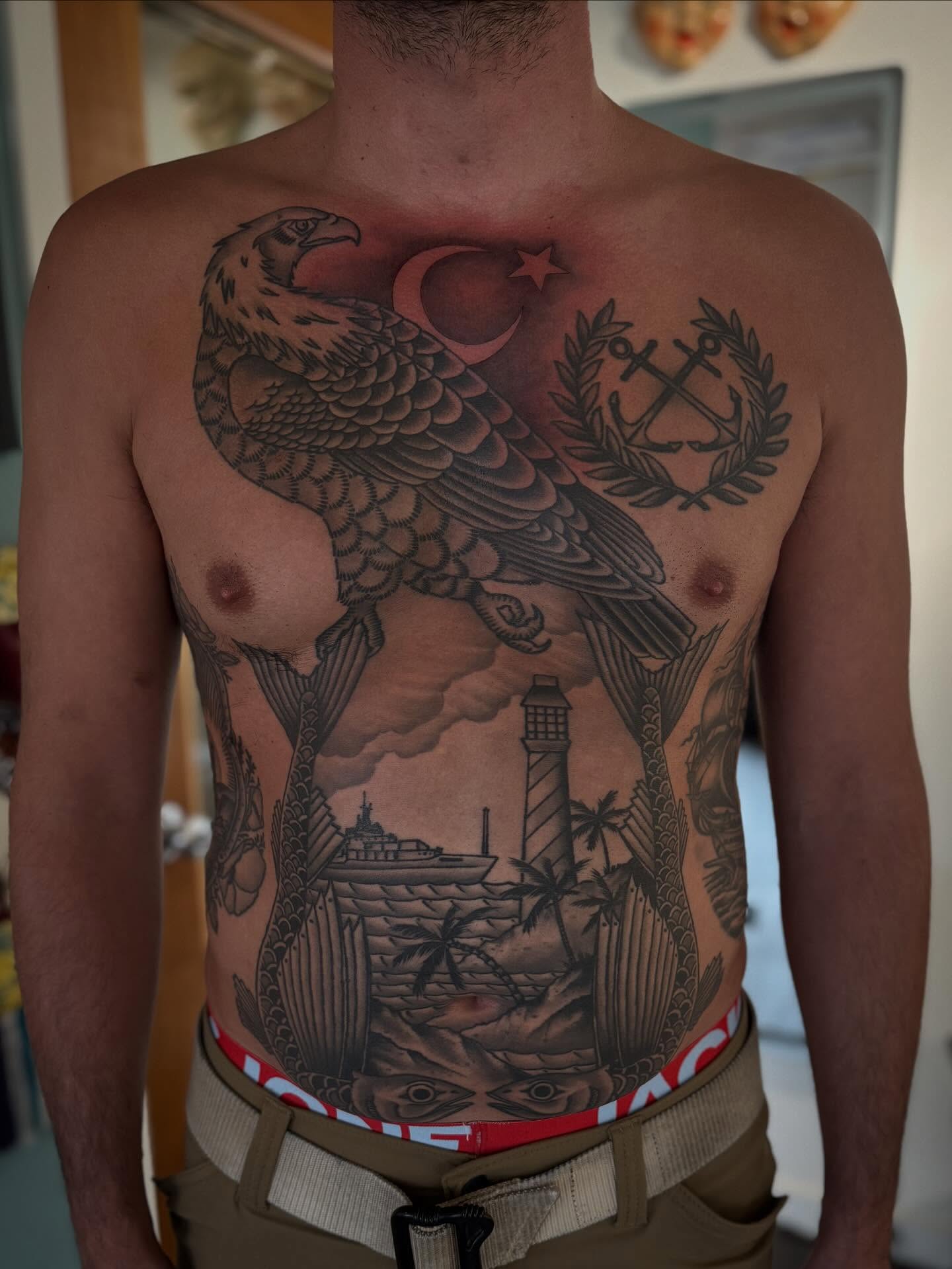 Eagle and lighthouse American traditional tattoo on the chest by Laurent Trelaun, San Francisco, California