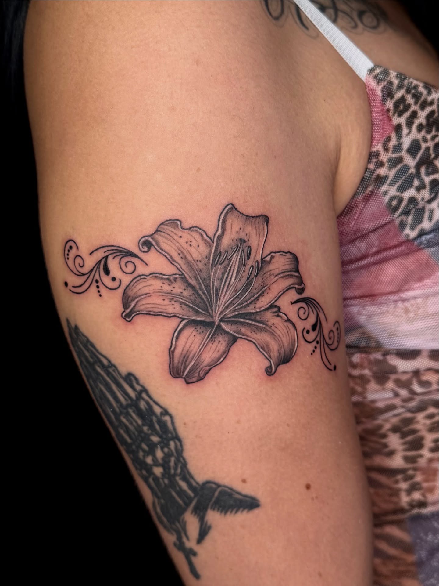 Lily black and grey tattoo on the forearm by Too Zen