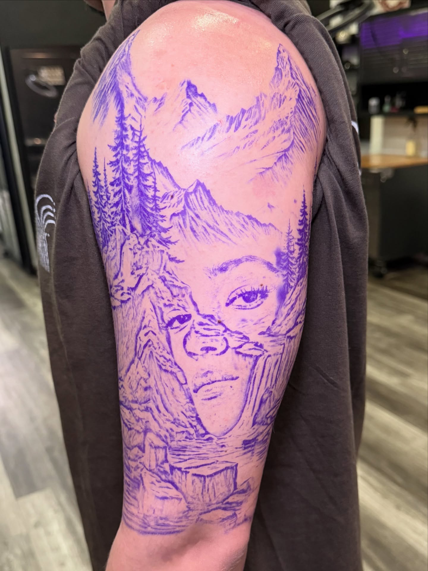 Portrait with mountain landscape realism tattoo on the forearm by Too Zen