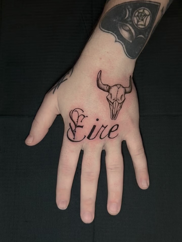Bull skull and cursive text geometric tattoo on the hand by Houston Tattoo🇺🇸👩🏻‍🎨💉