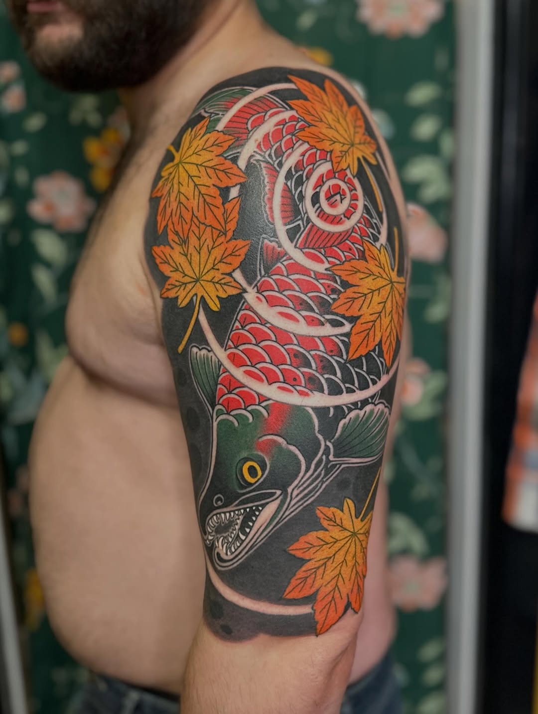 Koi fish and maple leaves Japanese tattoo on the upper arm by Megon Shore, Seattle, Washington