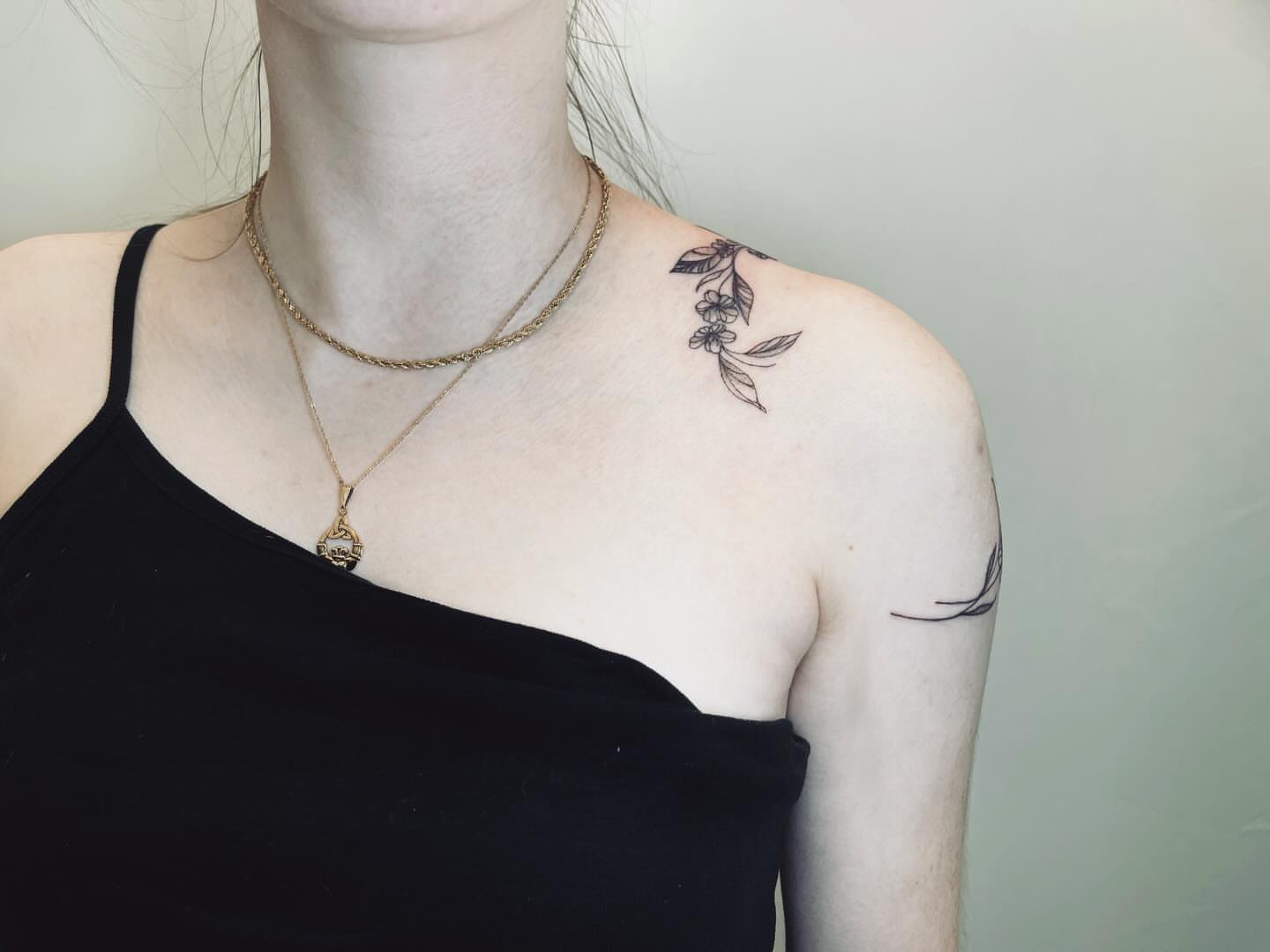 Flower vine black and grey tattoo on the shoulder by vivian