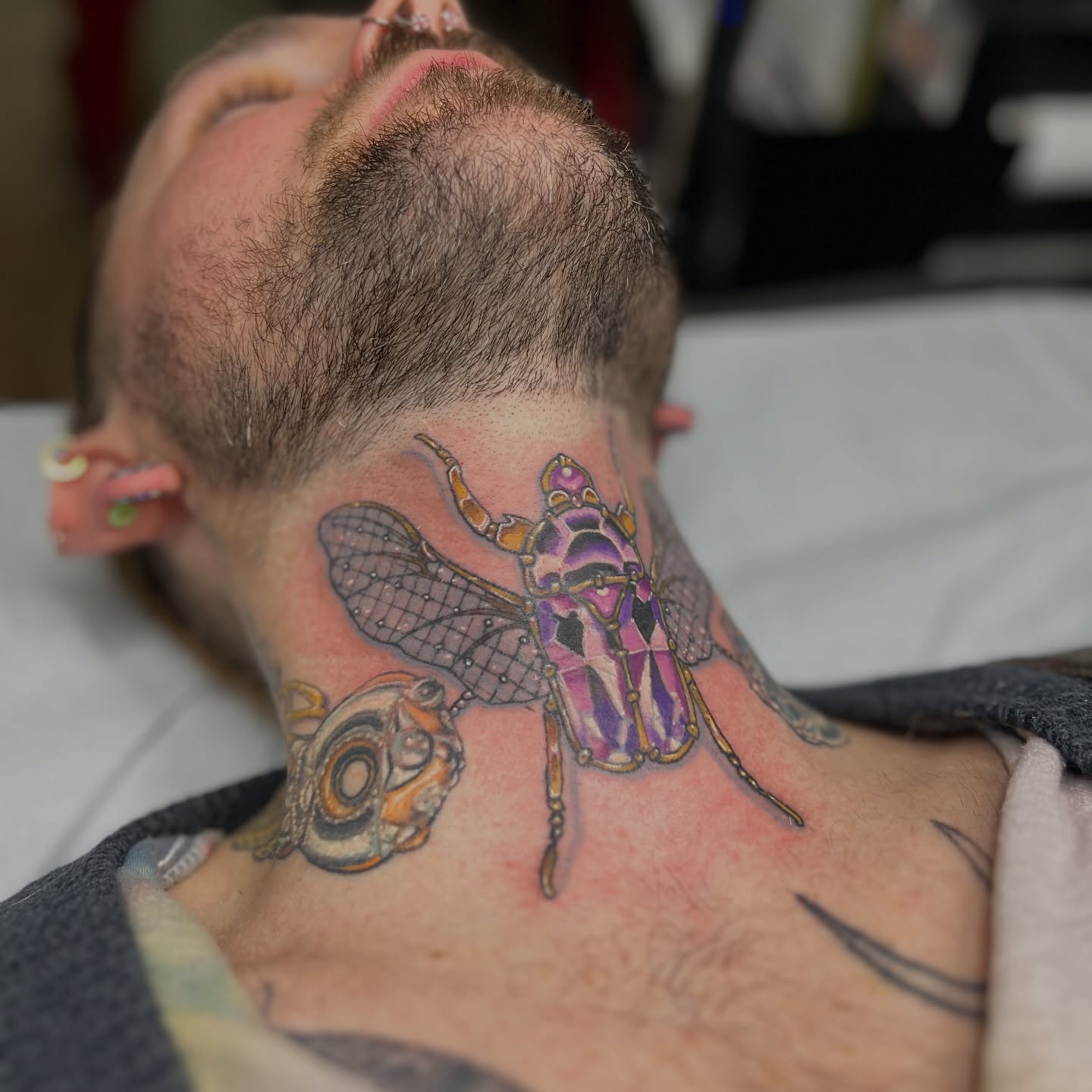 Insect geometric tattoo on the neck by Alex Santaloci