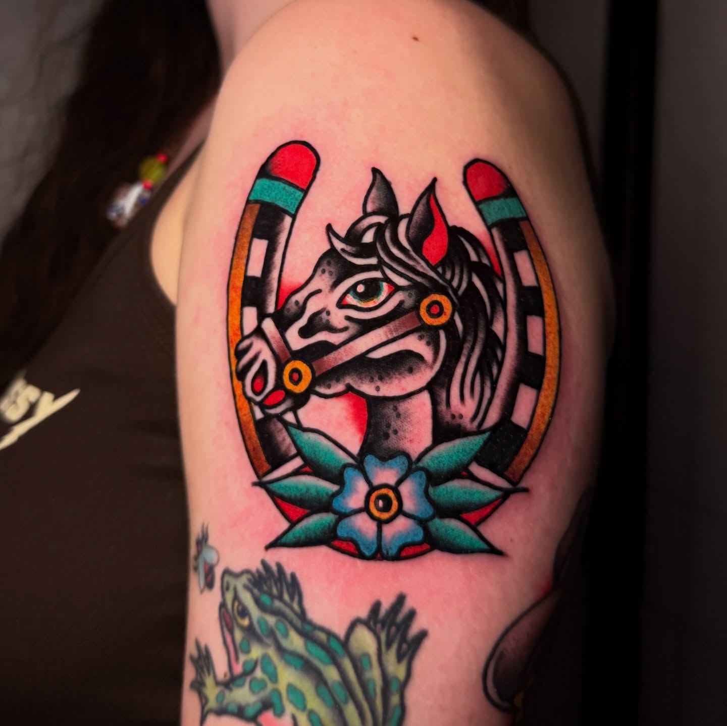 Cat and horseshoe American traditional tattoo on the shoulder by Stevie Lowenstein, Cincinnati, Ohio