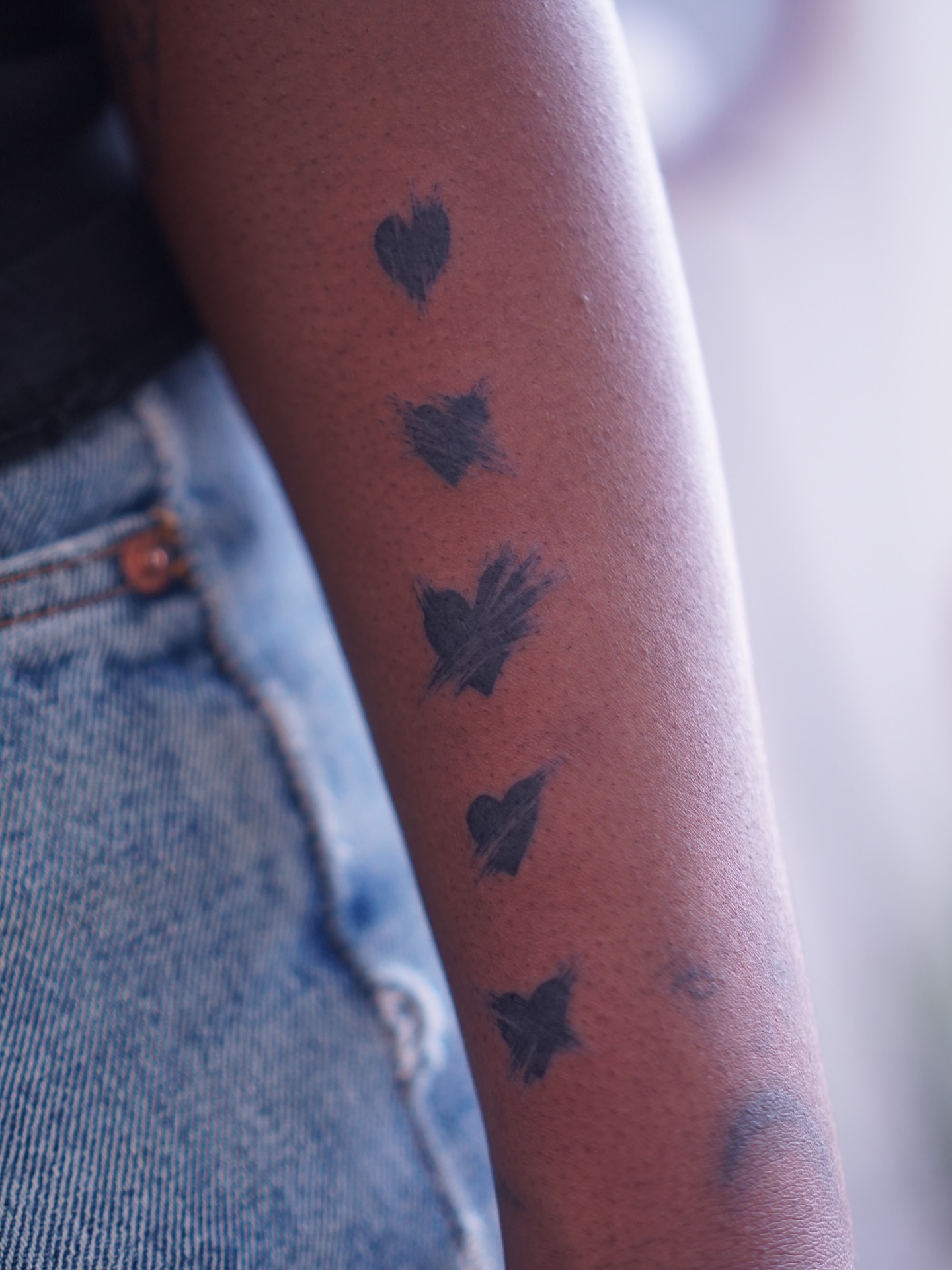 Hearts black and grey tattoo on the forearm by Young one 영원