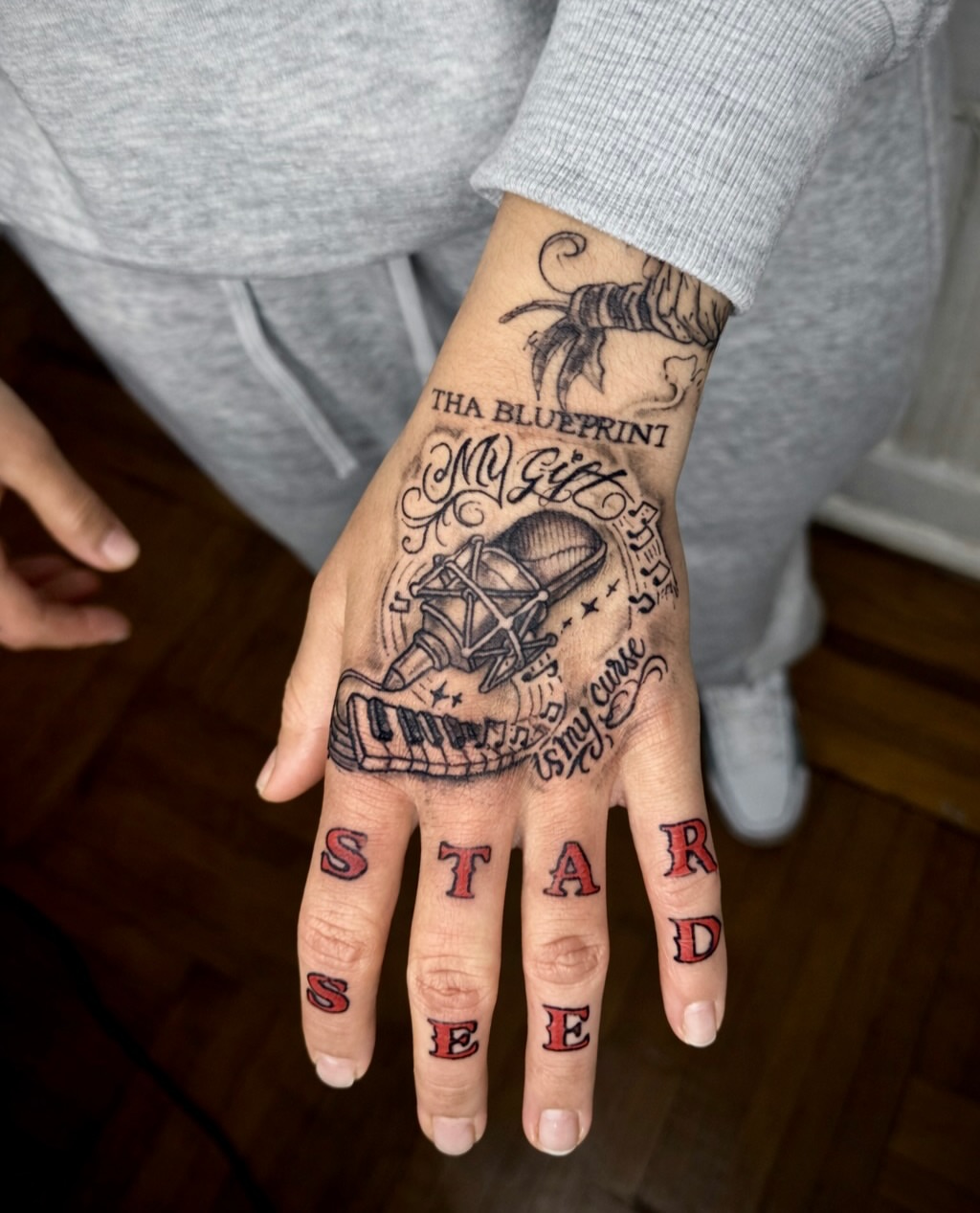 Tattooed lettering black and grey tattoo on the hand by JayyeSosa