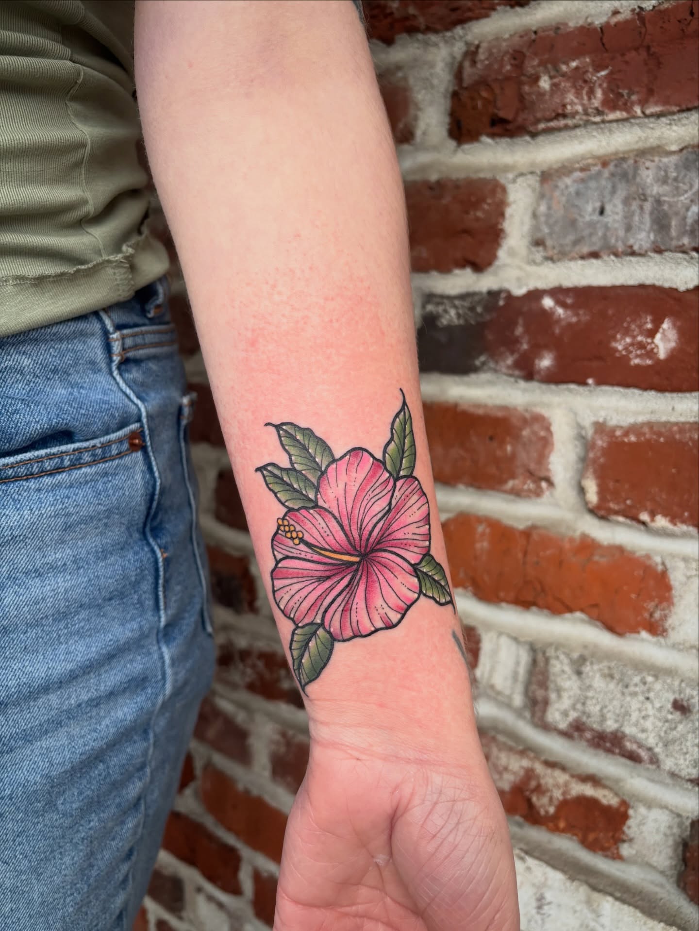 Hibiscus flower realism tattoo on the forearm by Malia Clark