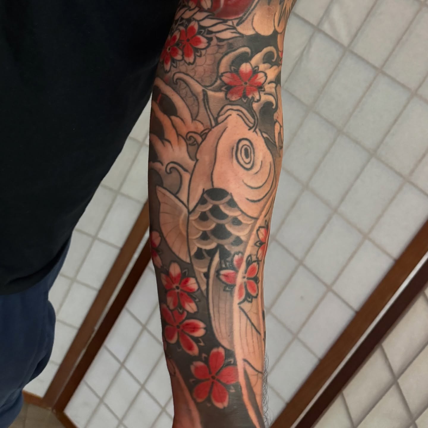 Koi fish and cherry blossoms japanese irezumi tattoo on the forearm by Dylan