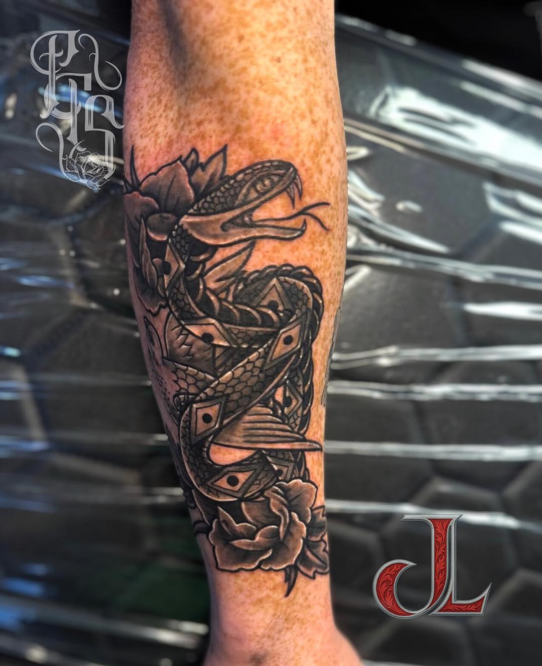 Snake and peony black and grey tattoo on the forearm by Faithful Tattoo Studio