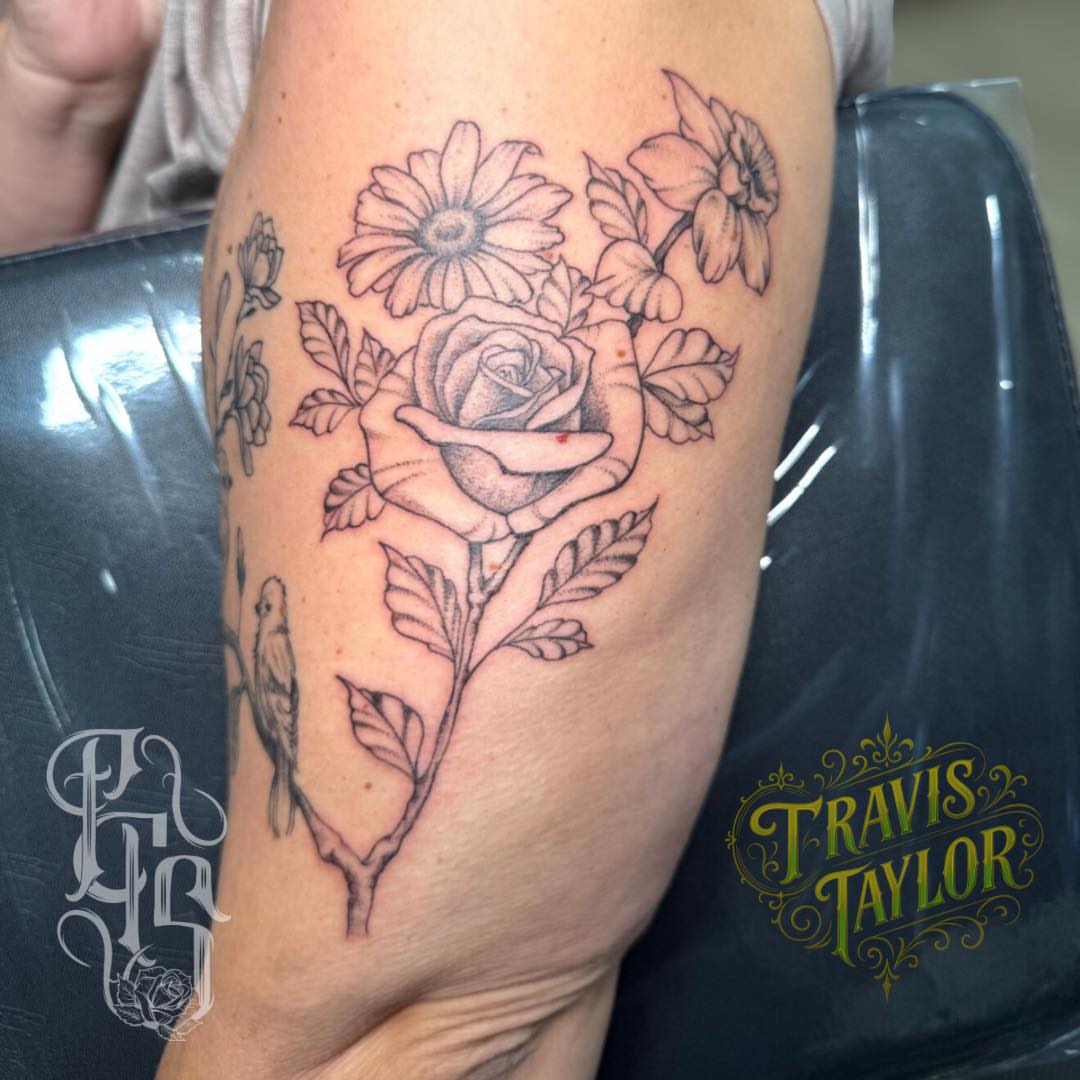 Rose and daisies black and grey tattoo on the forearm by Faithful Tattoo Studio