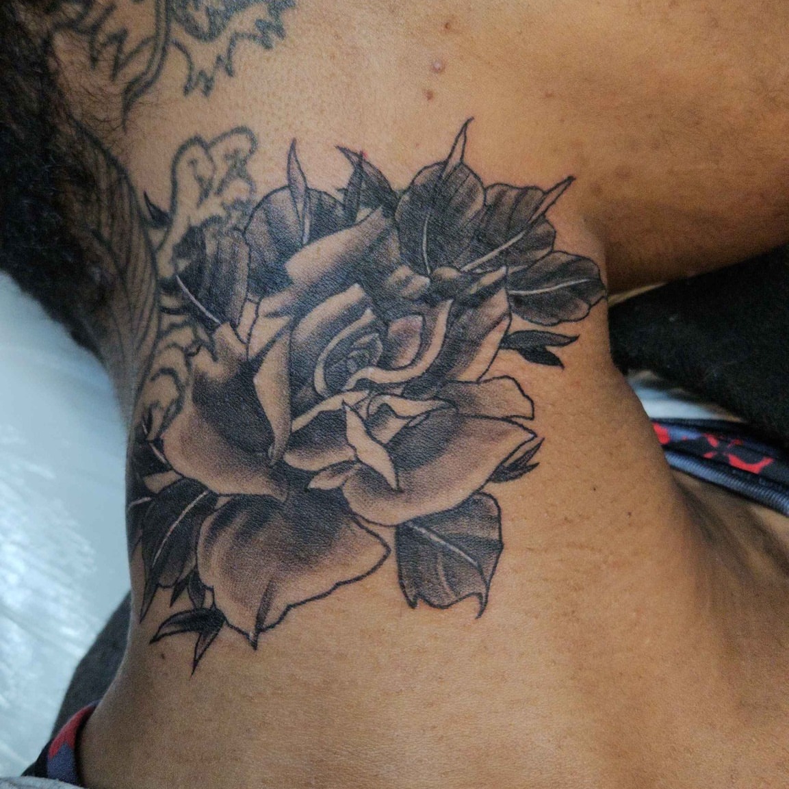 Flower black and grey tattoo by Iram Withencroft