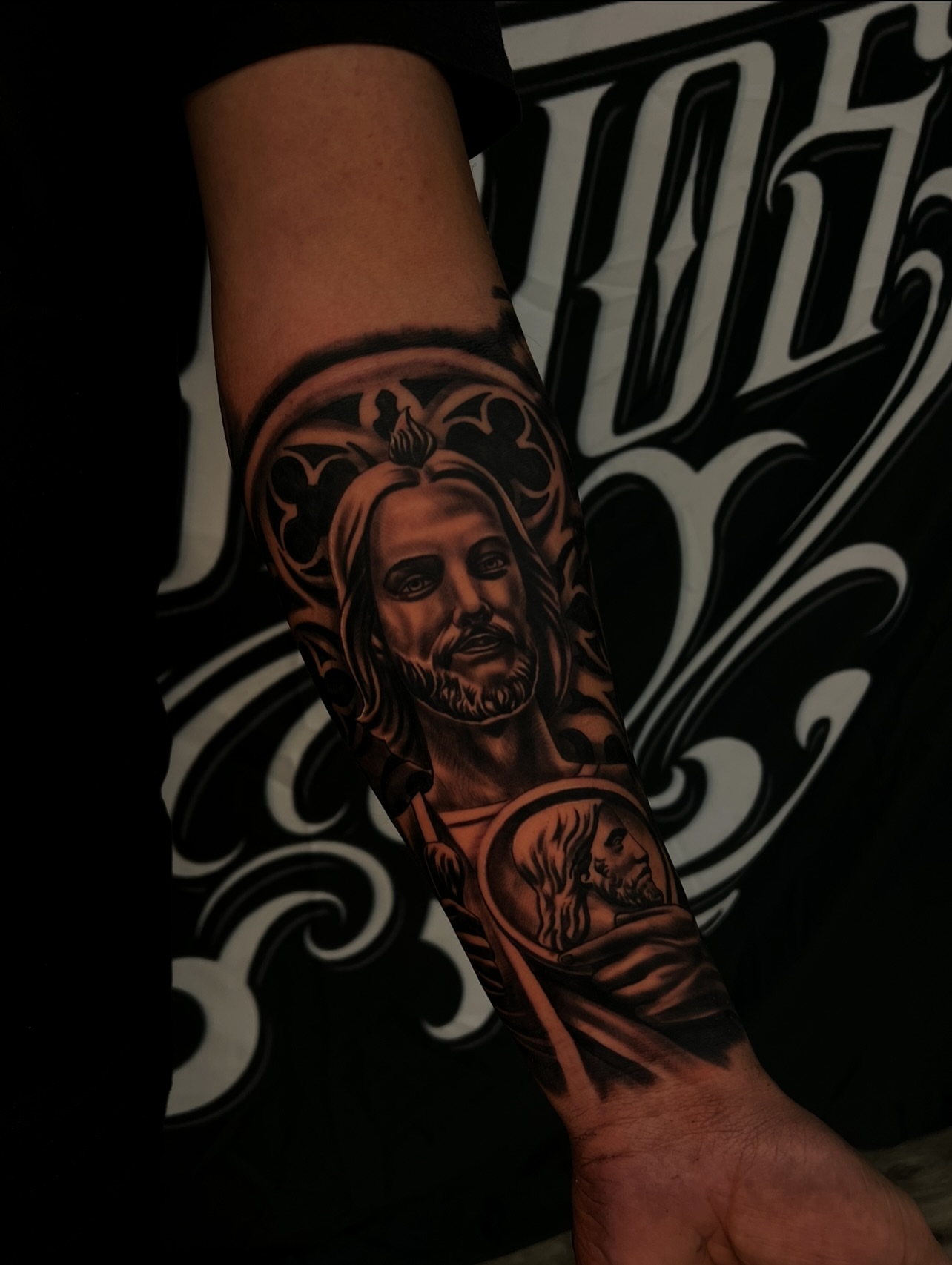 Religious figure black and grey tattoo on the forearm by Daniel Michael Perez