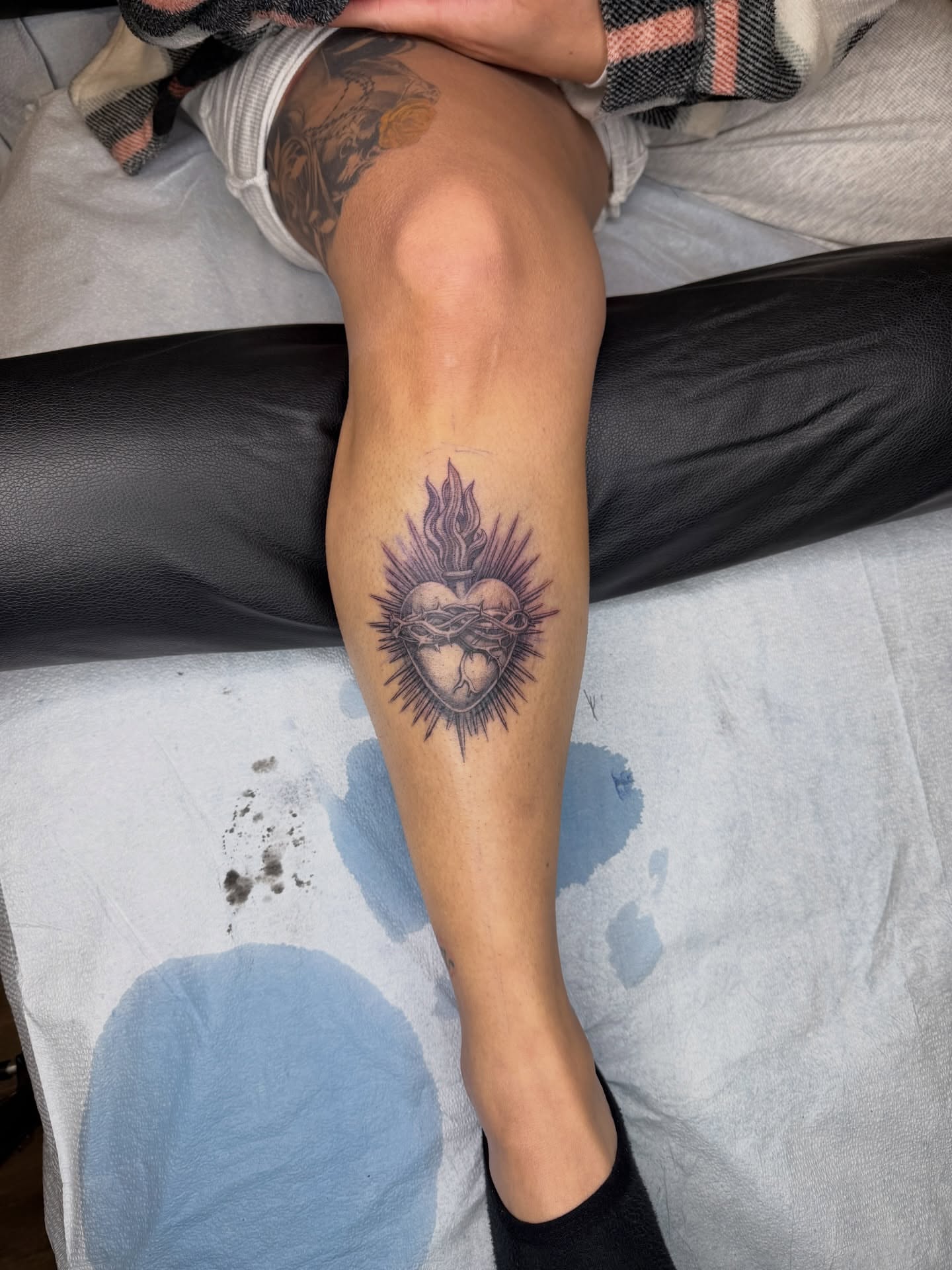 Heart with flame black and grey tattoo on the calf by Melissa Rose Moya
