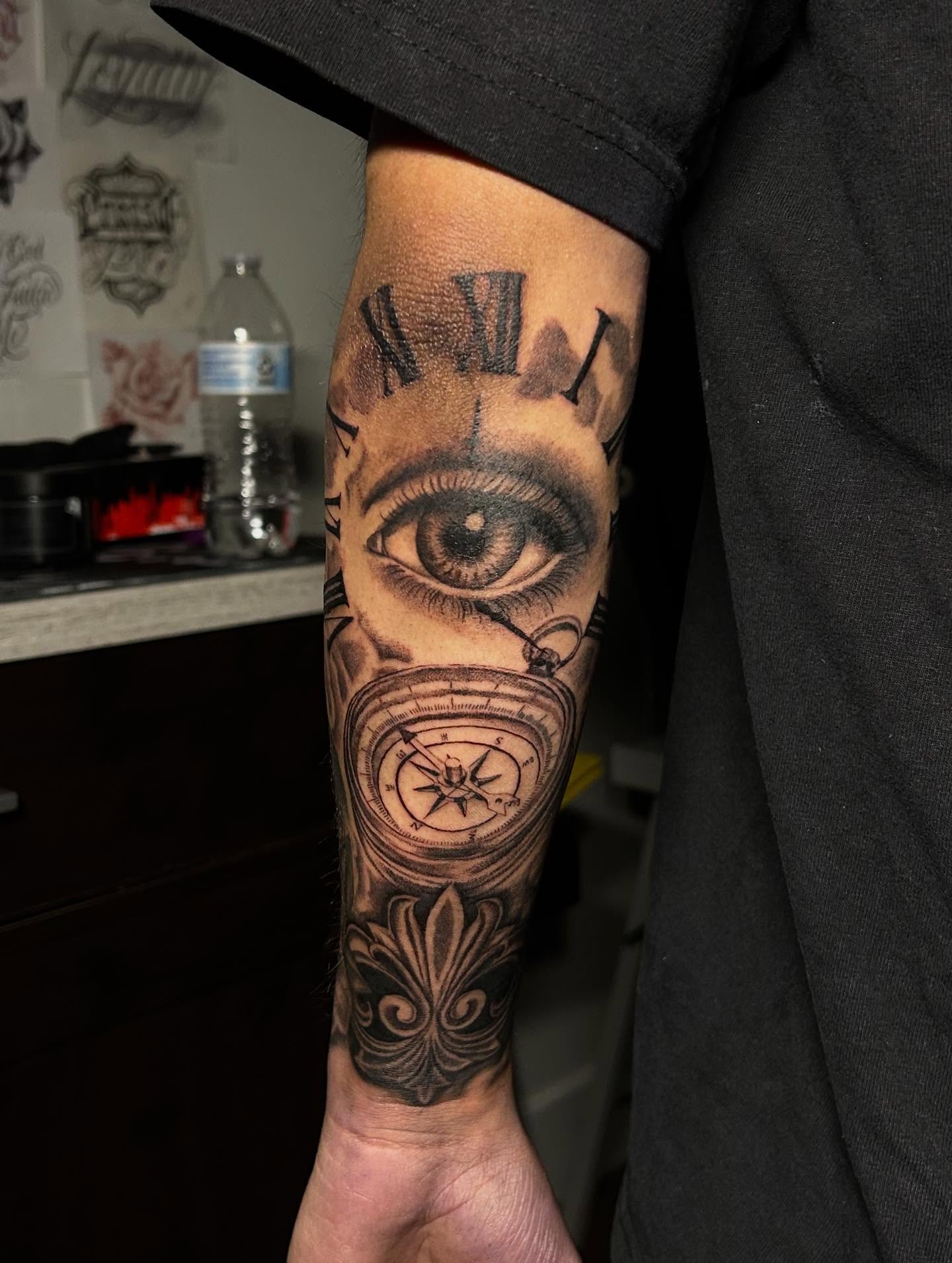 Eye and compass realism tattoo on the forearm by Ximena Favela