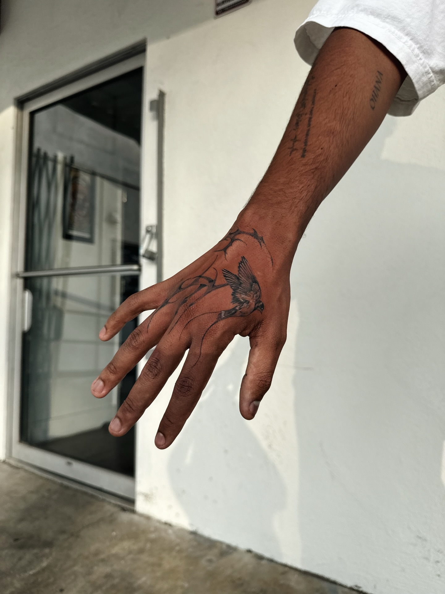 Bird black and grey tattoo on the hand by viktoria raquel