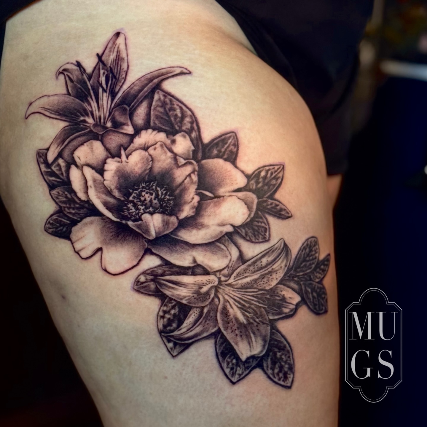 Floral arrangement black and grey tattoo on the thigh by Emily Andreozzi