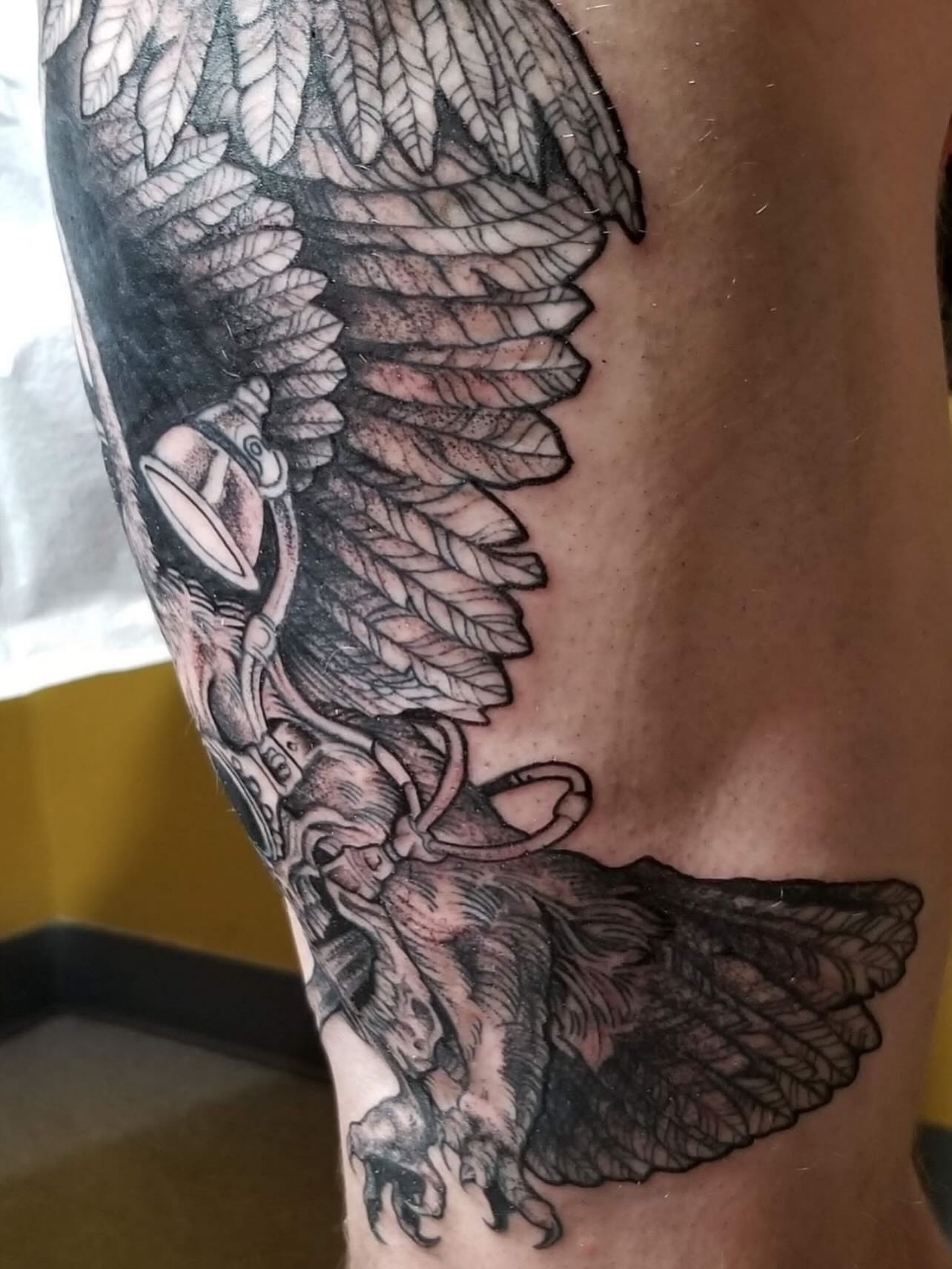 Eagle black and grey tattoo on the thigh by Jason Middelton