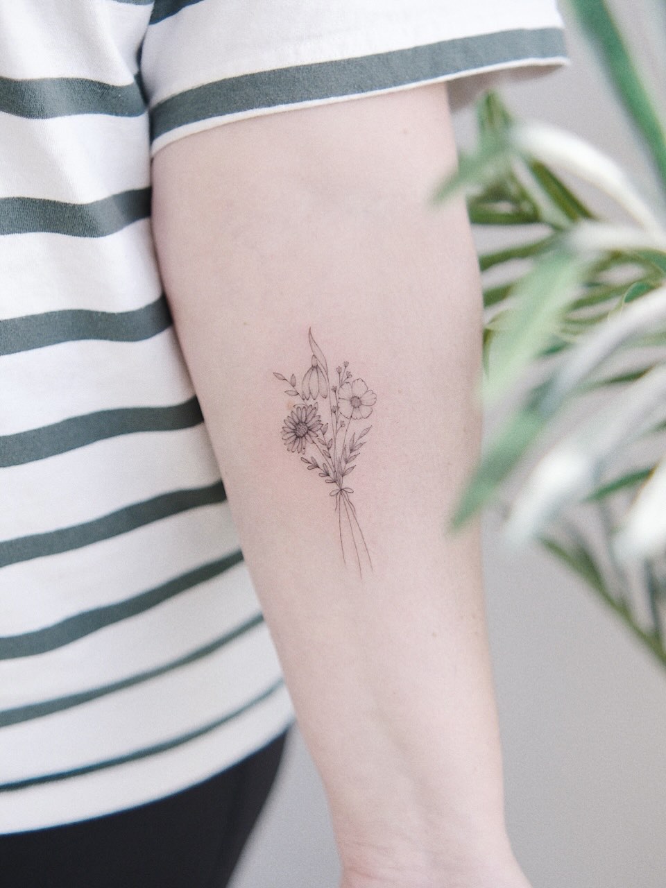 Floral bouquet fine line tattoo on the forearm by ginn ❀ fine line tattoo artist