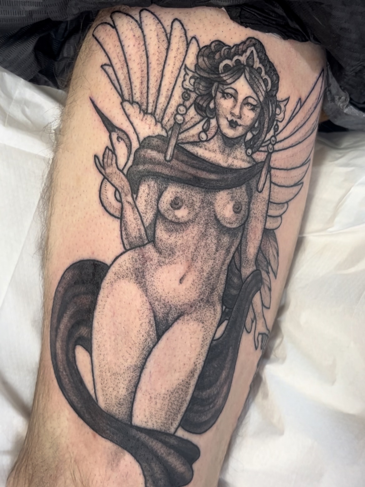 Mermaid with wings dotwork tattoo on the thigh by Emily