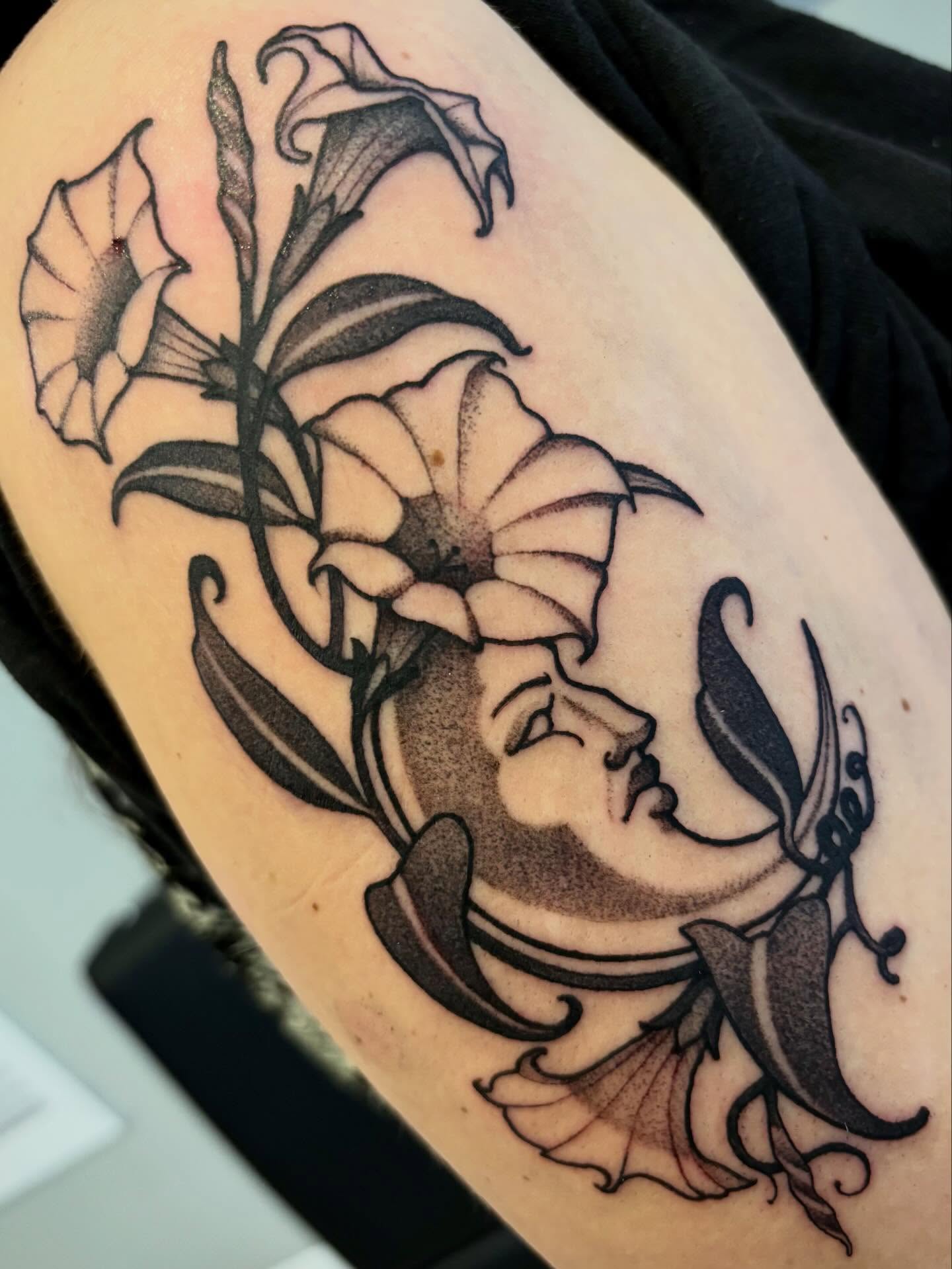 Moon and flowers black and grey tattoo on the thigh by Tara, Exeter, Pennsylvania