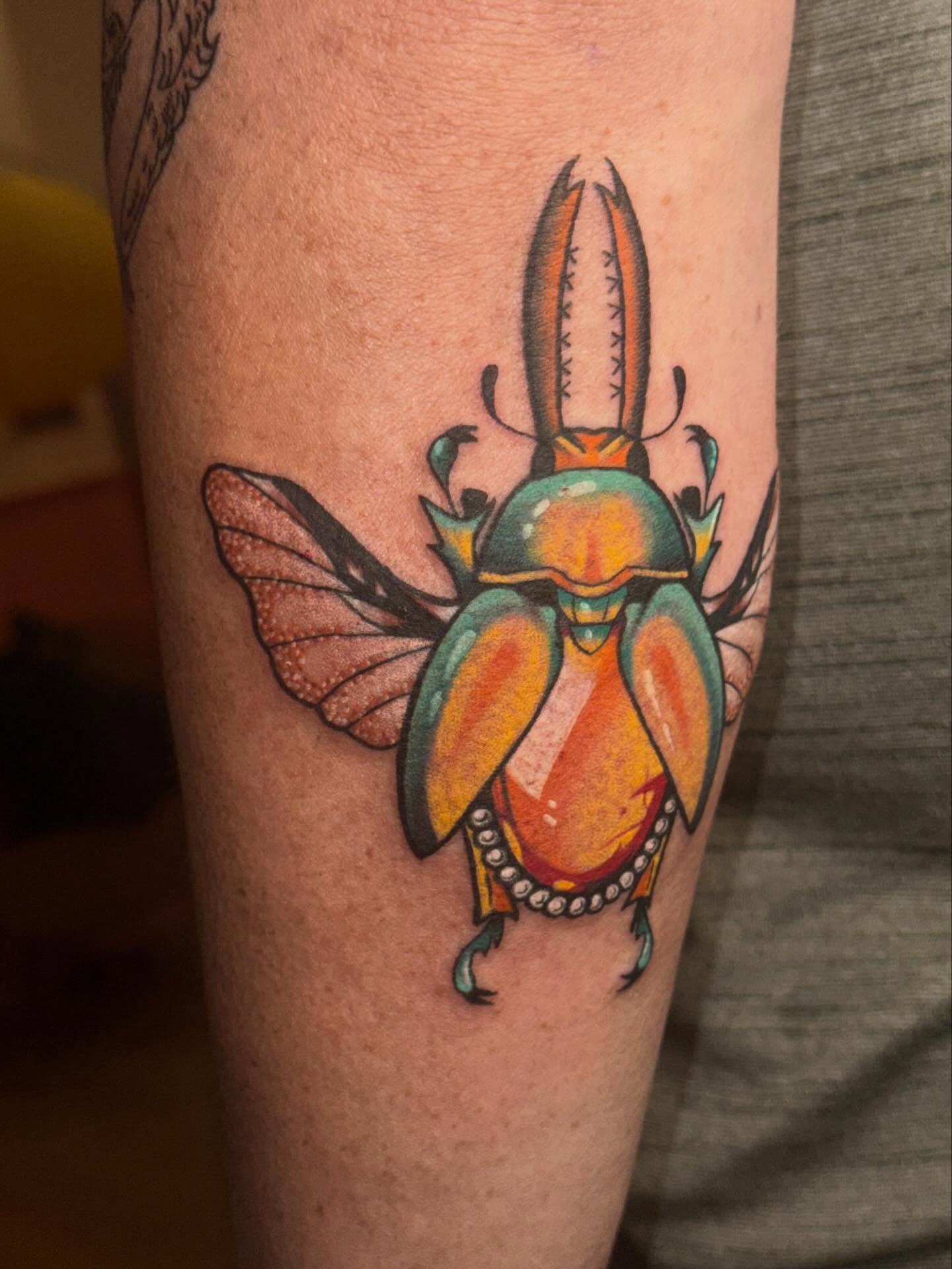 Scarab beetle American traditional tattoo on the forearm by Laurito