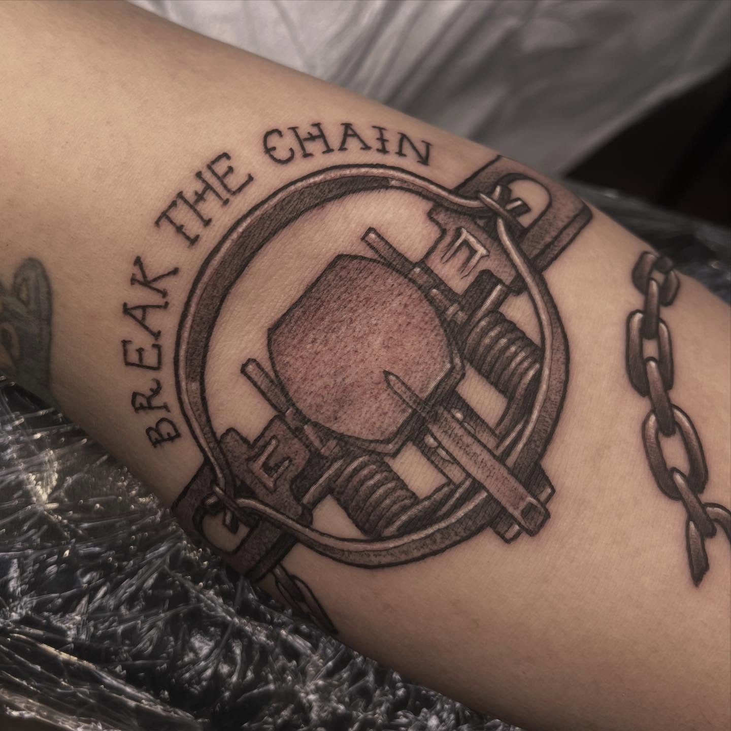 Break the chain black and grey tattoo on the forearm by Sarah Foltz