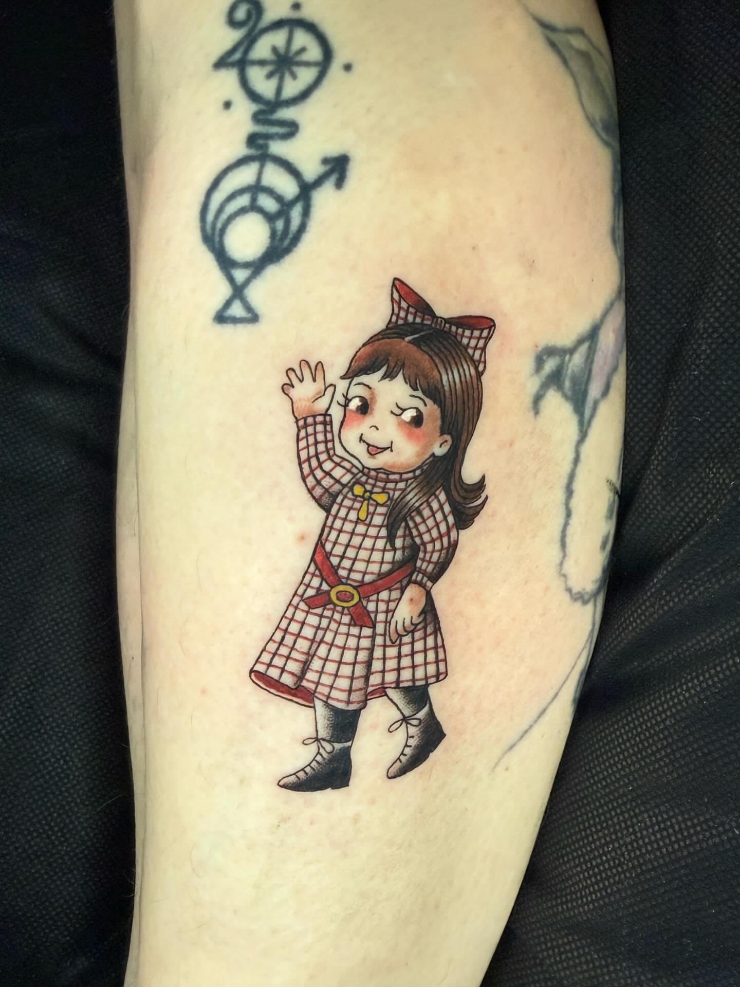 Little girl illustrative tattoo on the forearm by Katy Bisby