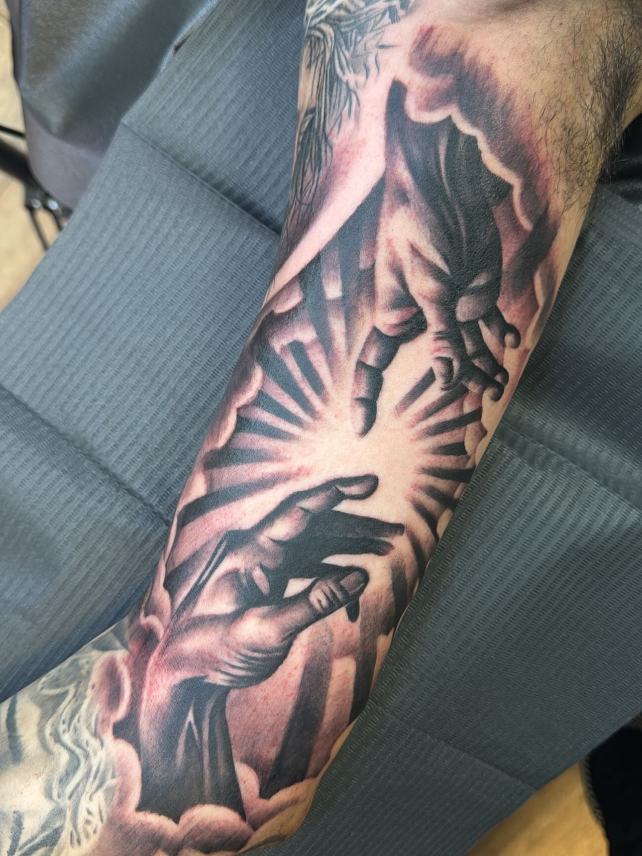 Religious scene realism tattoo on the forearm by Cedric Fleming