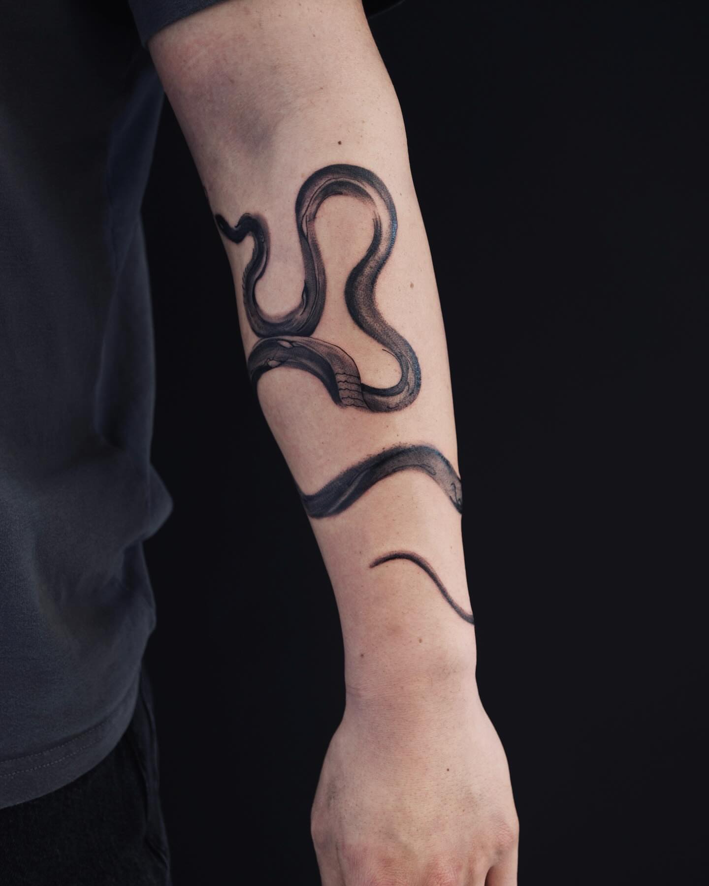 Snake black and grey tattoo on the forearm by MJ tattooist