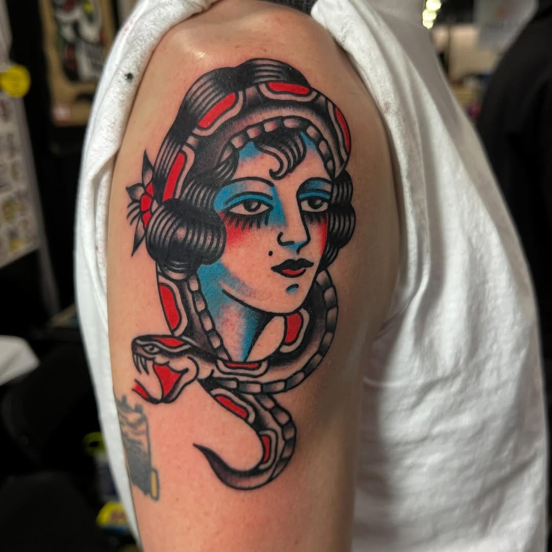 Woman and snake neo-traditional tattoo on the shoulder by Darren Malekoff
