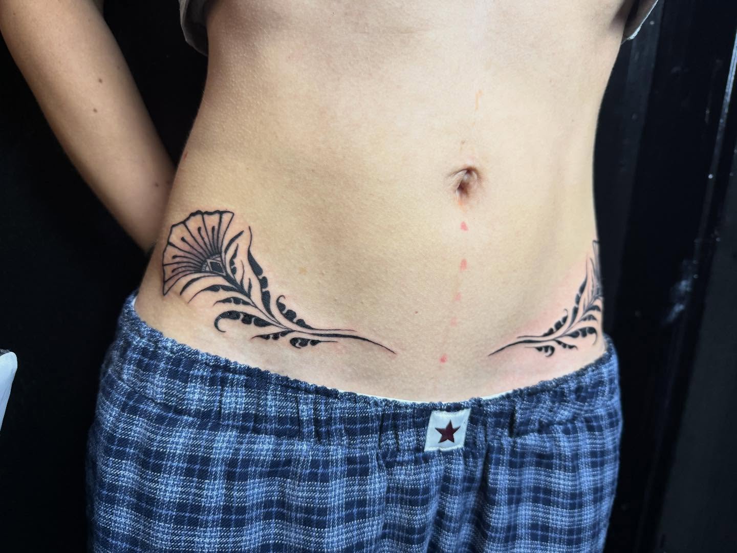 Floral design black and grey tattoo on the torso by savannah