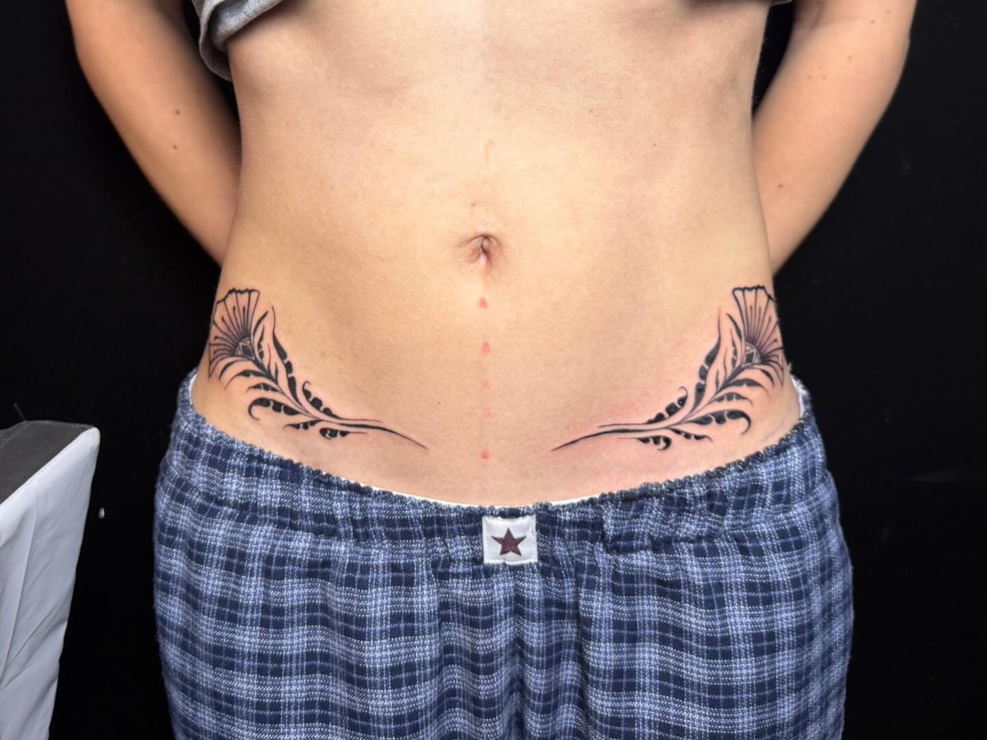 Floral design black and grey tattoo on the torso by savannah