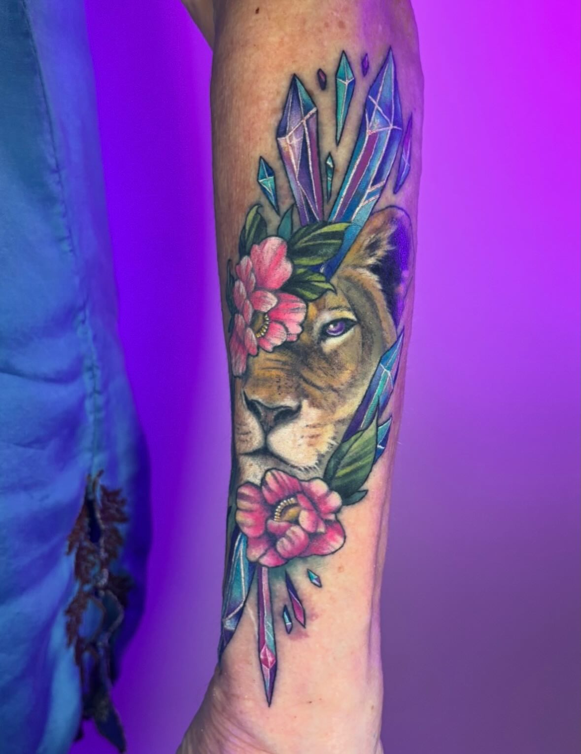 Lion with flowers realism tattoo on the forearm by Chelsey Moore, Albuquerque, New Mexico