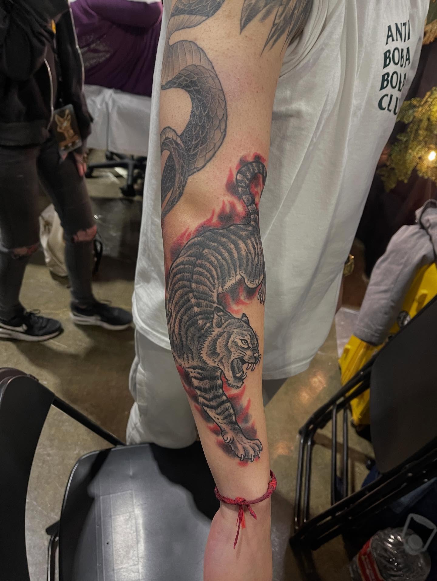 Tiger and snake American traditional tattoo on the forearm by Don Juan