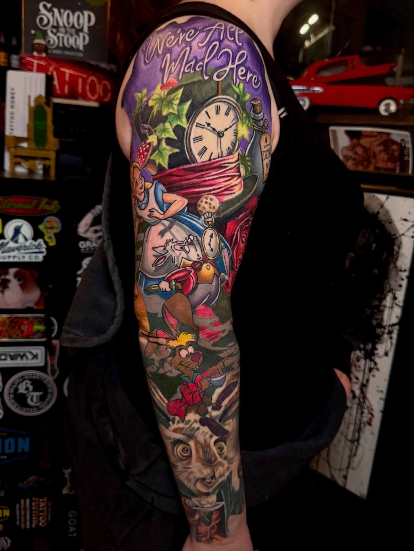 Alice in Wonderland characters illustrative tattoo on the forearm by Scott Pizer