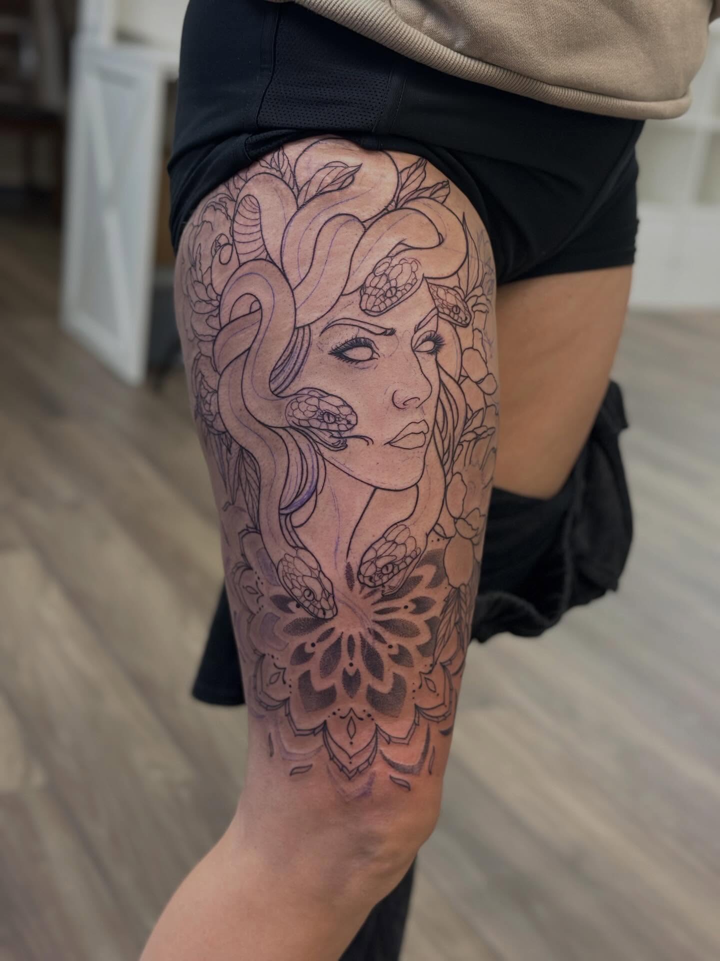 Woman with snakes fine line tattoo on the thigh by Teddi Bird