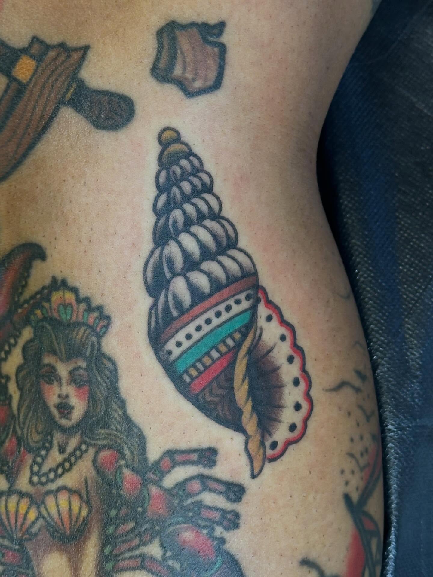Shell American traditional tattoo on the thigh by Jordan Rubin, Dunedin, Florida