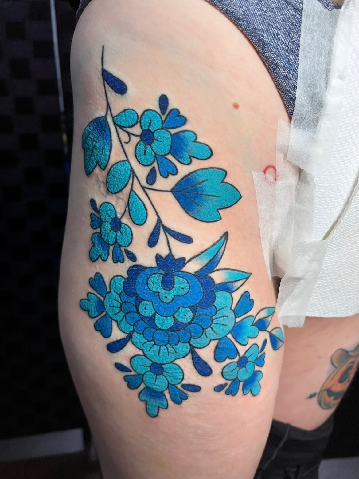 Blue floral bouquet dotwork tattoo on the thigh by Alena McDonald