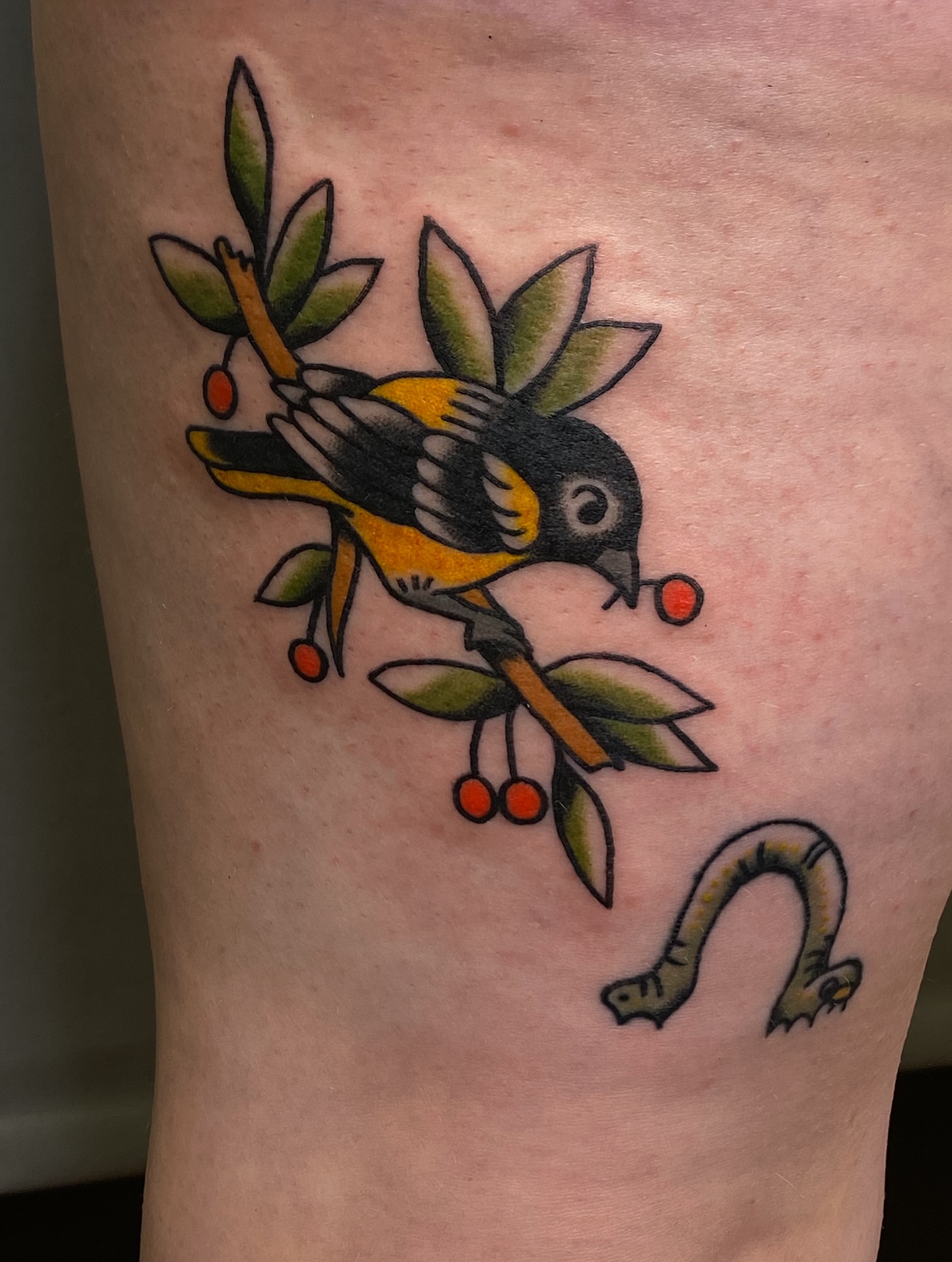 Bird and cherry American traditional tattoo on the forearm by Corinne Carter