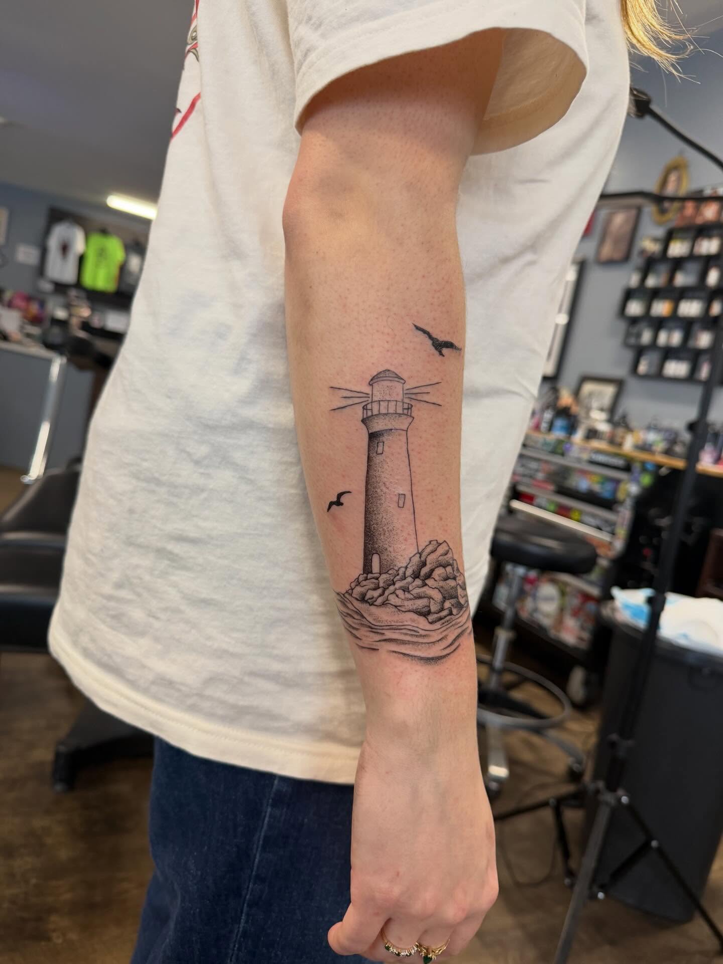 Lighthouse black and grey tattoo on the forearm by Hope Powell, Vancouver, Washington