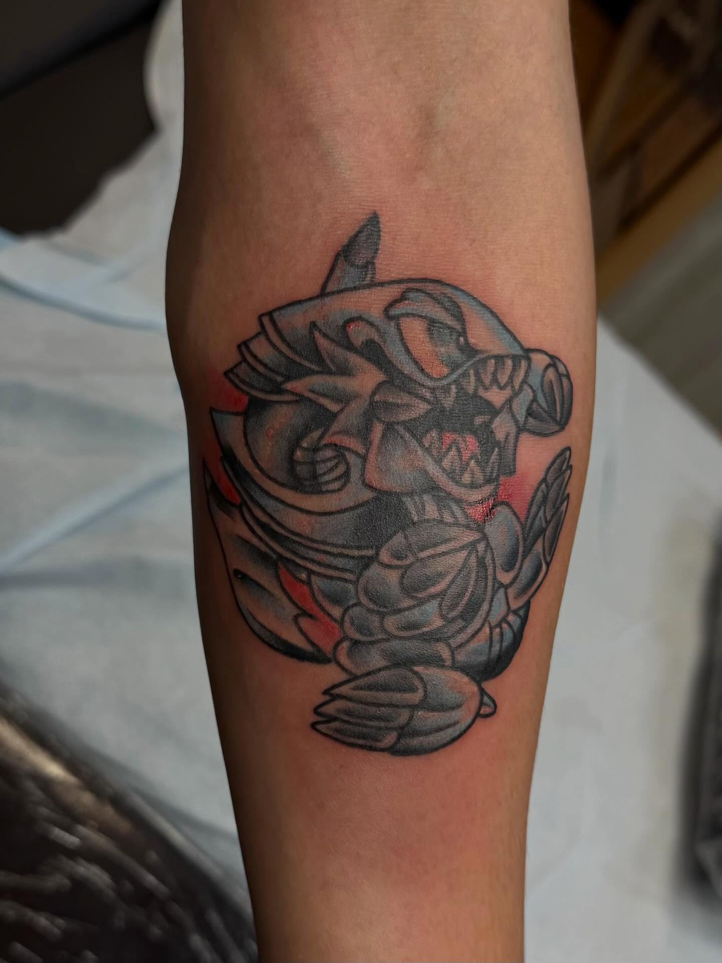 Mech black and grey tattoo on the forearm by Madilynn Klassen