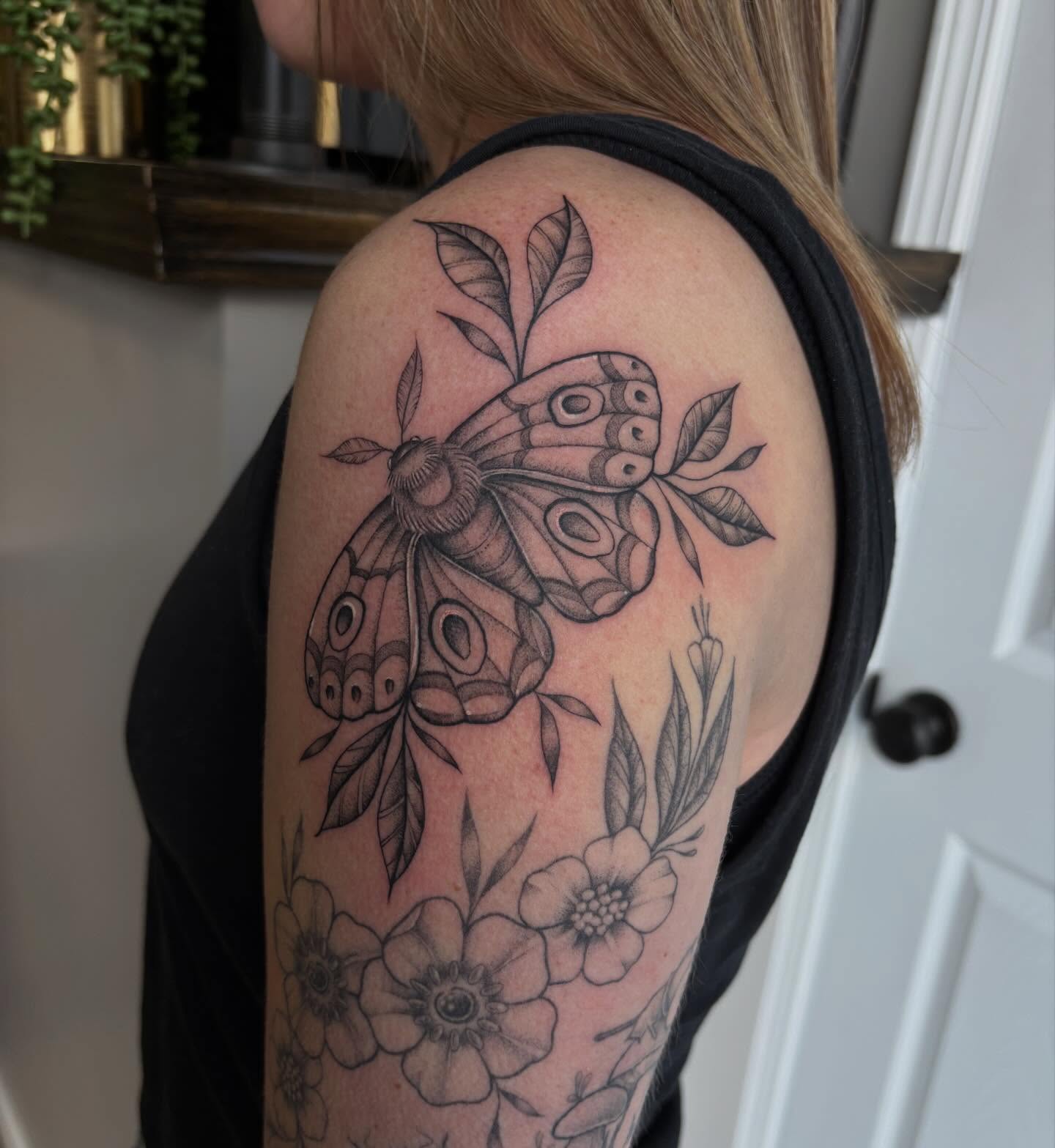 Butterfly and flowers realism tattoo on the shoulder by Hailey Nicole