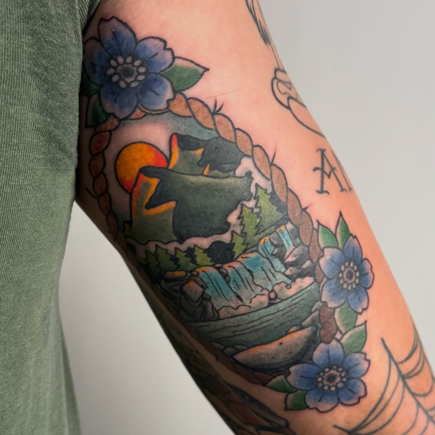 Boat and sunset American traditional tattoo on the forearm by autumn sky