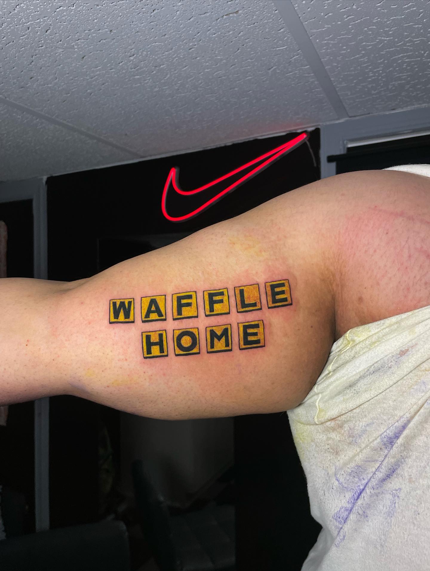 Waffle home lettering script tattoo on the forearm by Nikko